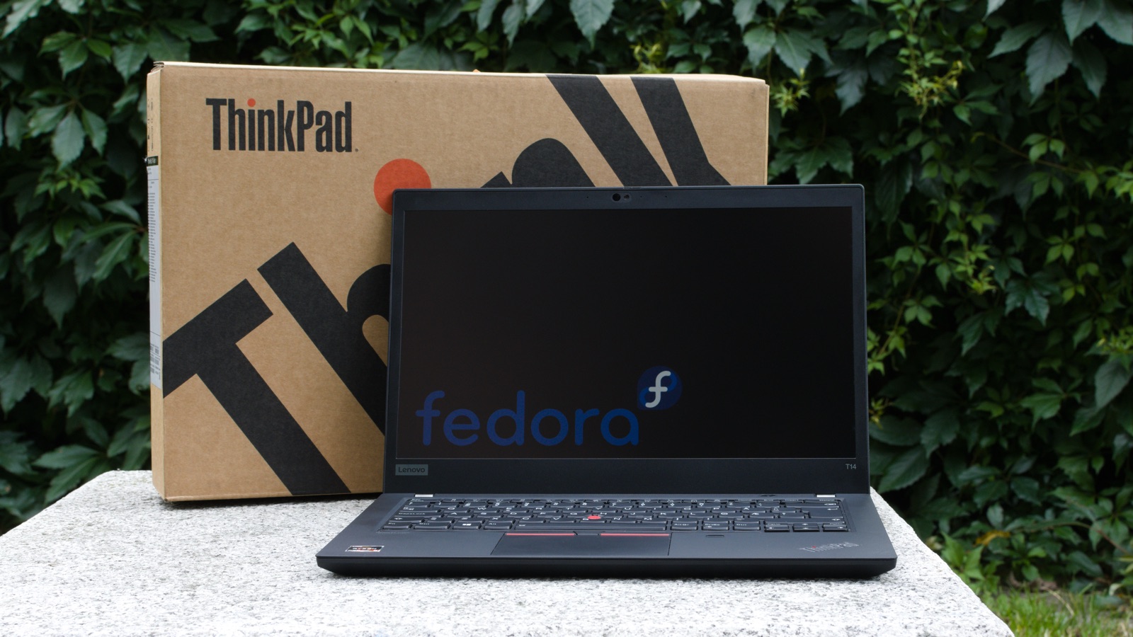 Lenovo ThinkPad T14 laptop open next to its ThinkPad retail box