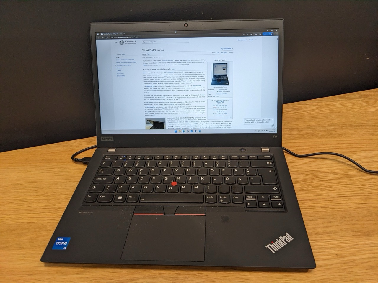 ThinkPad T14 open on a desk, showing the keyboard, TrackPoint and trackpad