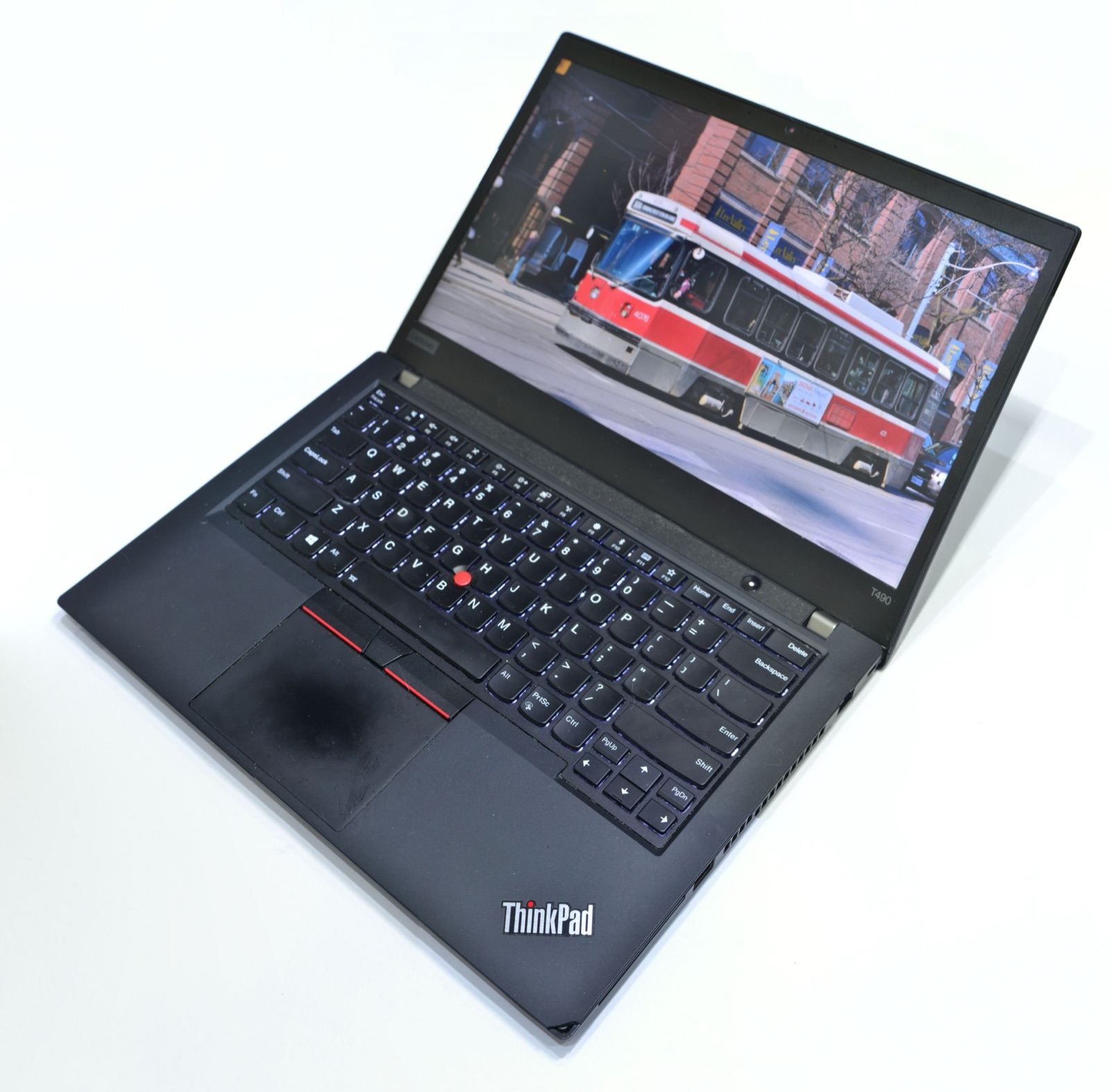 ThinkPad laptop open showing a vivid, colourful photo on its display